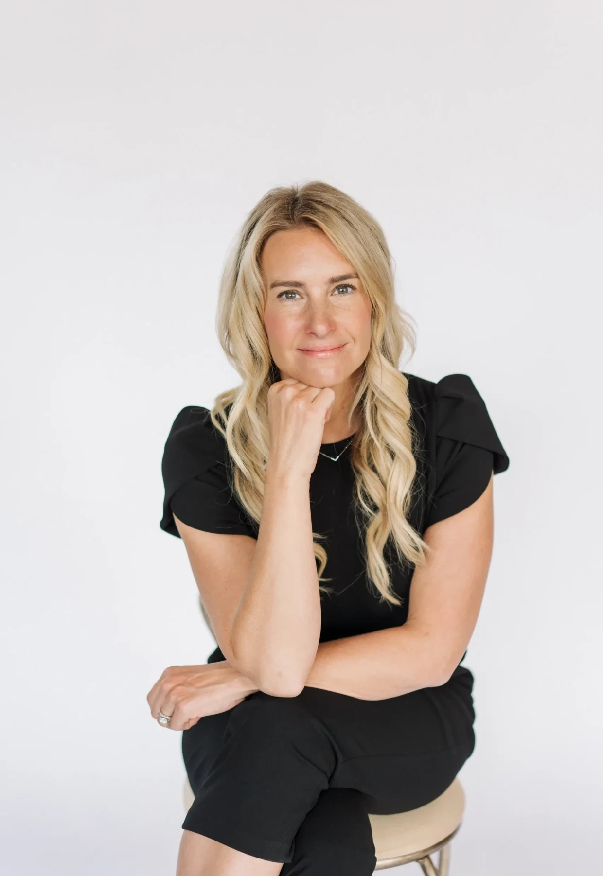 Woman in black outfit smiling