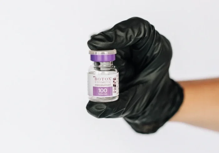 Small bottle of Botox, black glove