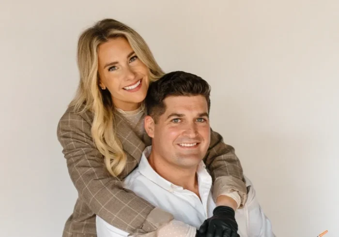 Smiling couple embracing against white background